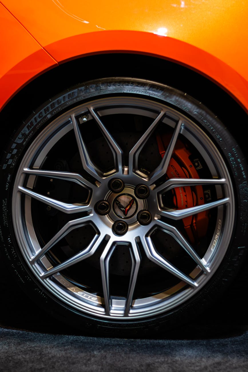 close up of orange corvette wheel with chrome rims