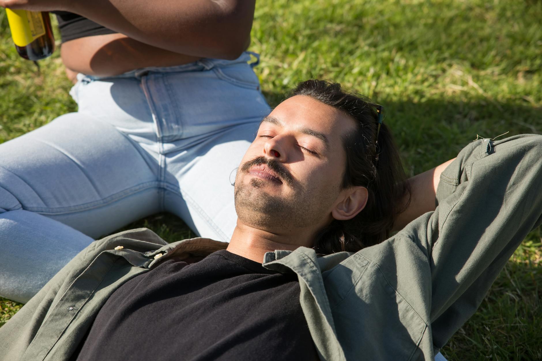 a man with a mustache lying on a person s lap